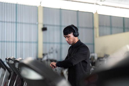 Treadmill Workout. A man checking his fitness tracker while exercising on a treadmill.の写真素材