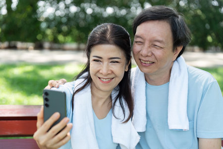 Senior Couple Enjoying Life. A happy senior couple taking a selfie together in the park.の写真素材