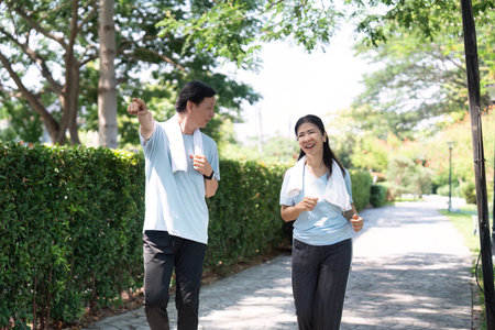 Joyful Seniors Walking Together. A senior couple laughing and chatting while walking in the park.の写真素材