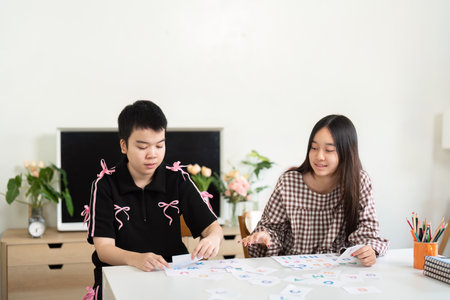Back to School and Interactive Learning. Students sorting educational materials during a creative session.の写真素材
