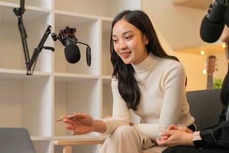 Engaging Discussion. Woman smiling while sharing ideas in a podcast setting.の写真素材