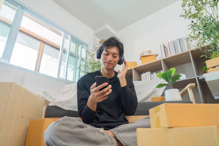 Listening to Music. Young man enjoying music with headphones at home.