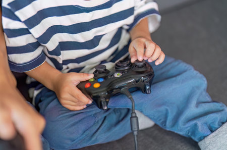 Gaming Fun. Child holding a video game controller, engaged in play.