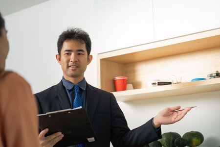 Real Estate Consultation. Agent presenting property options to potential buyer.の写真素材