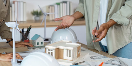 Architectural Discussion. Professionals explaining design concepts with a model in a collaborative...