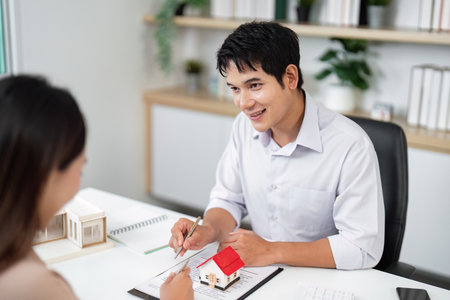 Real Estate Consultation. Professional agent discussing property options with a client.の写真素材