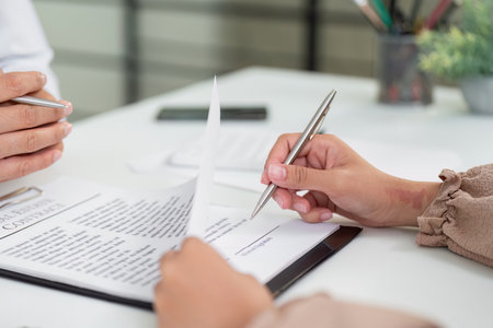 Real Estate Agreement. Client reviewing contract with an agent.の写真素材