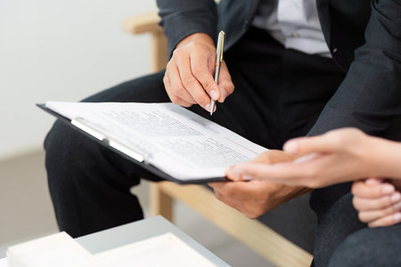 Real Estate Agent Signing Documents with Clientsの写真素材