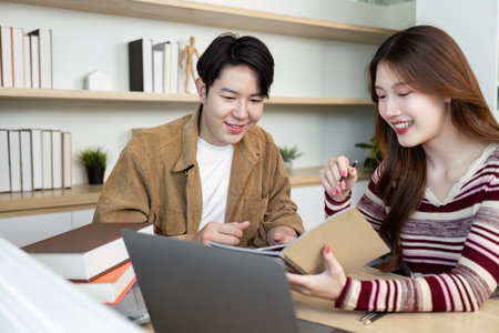 Back to School. Students sharing knowledge and resources in a bright study space.の写真素材