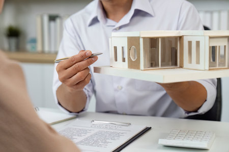 Real Estate Agent Assisting Client with Property Paperworkの写真素材