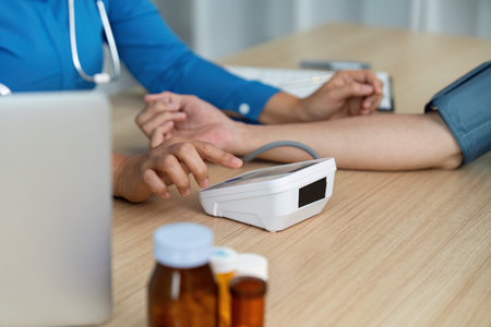 Doctor monitoring patient health with medical equipment in a clinical environmentの写真素材