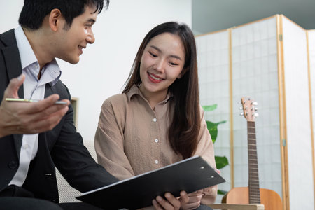 Real Estate Discussion. Agent and client engaging in a property consultation.の写真素材