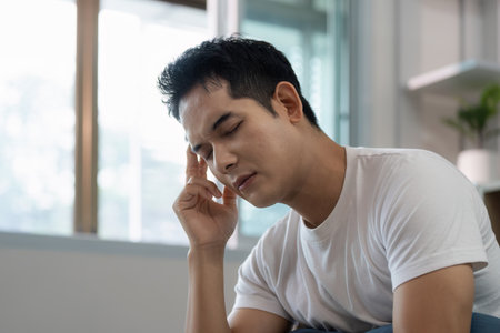 Young man dealing with stress and tension at home.の写真素材
