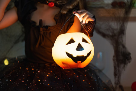Halloween Fun. Child holding a pumpkin bucket with a smiling face.の写真素材