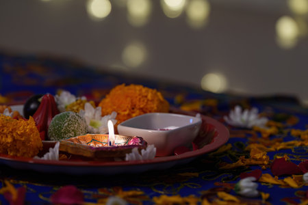 Diwali Festivity. Close-up of colorful sweets and flowers on a decorative plate.の写真素材