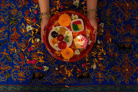 Colorful Puja Thali with Ritual Offerings and Flowersの写真素材