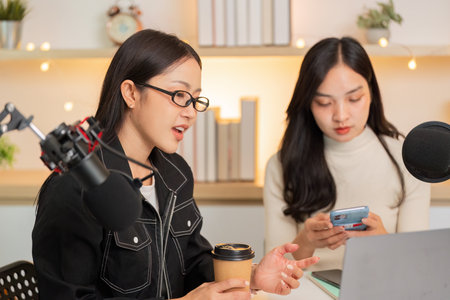 LGBT women discussing ideas with coffee in a vibrant studioの写真素材