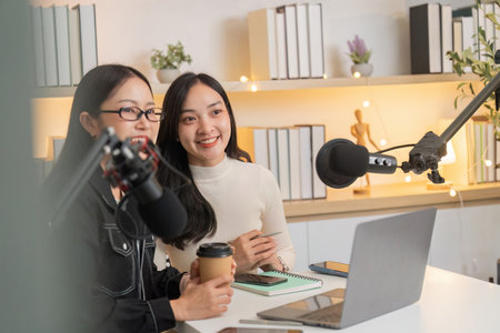 Friendly podcast hosts enjoying a creative discussionの写真素材