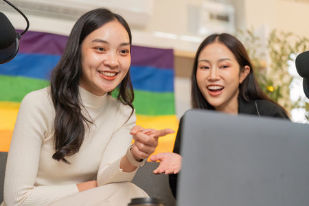 LGBTQ friends discussing digital content in a cozy studioの写真素材