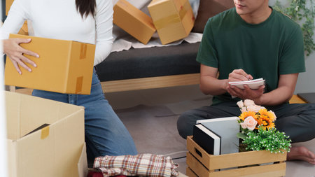 Couple Collaborating to Unpack Boxes in Cozy Living Room