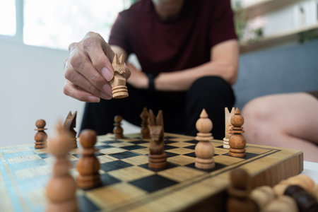 Chess Game Strategy. Two friends engaged in a thoughtful chess match indoors.