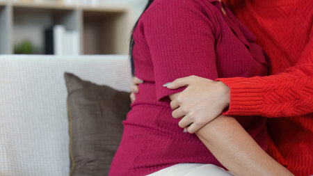 Tender Embrace. Close-up of two women hugging in a cozy setting.の写真素材