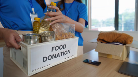 Volunteers organizing food donations for community welfareの写真素材