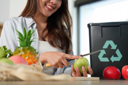 Eco-Friendly Living: Woman Enjoying Healthy Cooking with Fresh Ingredientsの写真素材