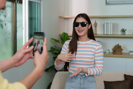 Young Woman Taking Selfie While Posing with Sunglasses
