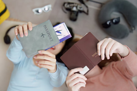 Travel Planning. Friends showing their passports and travel money, excited for their trip.の写真素材