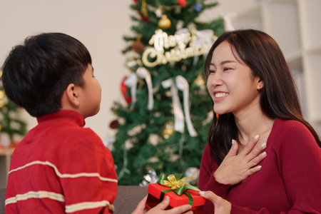 Joyful moment between mother and son exchanging gifts