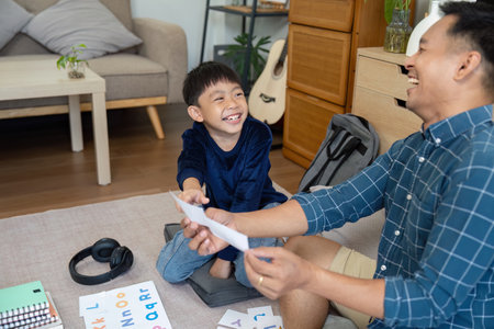 Father and Son Sharing Laughter. Engaging in playful learning activities.