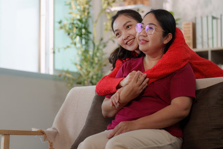Emotional connection. Young woman embracing her mother, showcasing love and support.の写真素材