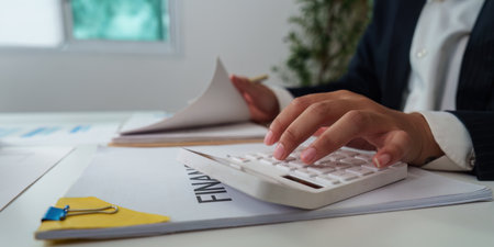 Financial Management. Professional calculating financial data while reviewing documents.の写真素材