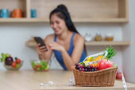 Food Wellness: Colorful Fruit Basket with Healthy Snacks and Digital Engagementの写真素材