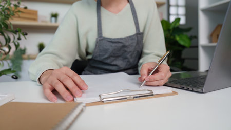 Focused Individual Writing in a Modern Office Setting