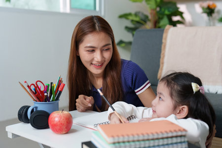 Supportive Learning: Mother Assisting Daughter with Homework