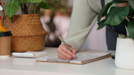 Creative Professional Taking Notes in a Bright Workspace