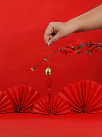 Chinese New Year celebration with red decorations and a golden bellの写真素材