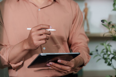 Digital Transformation. Professional using tablet for remote work and planning.