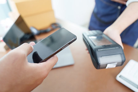 Digital Payment. Customer using smartphone for contactless payment.の写真素材