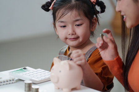 Financial Literacy. Child learning to save money with piggy banks and coins.の写真素材