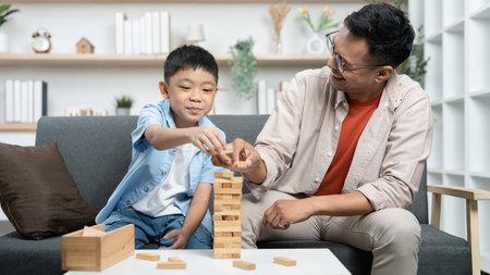Family Bonding. Father and son playing Jenga together at home.の写真素材