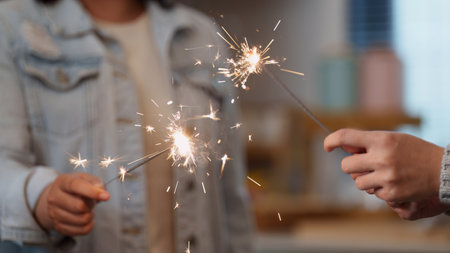 Celebrating with sparklers at a joyful party atmosphereの写真素材