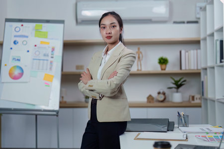 Professional woman in business attire standing confidently in office