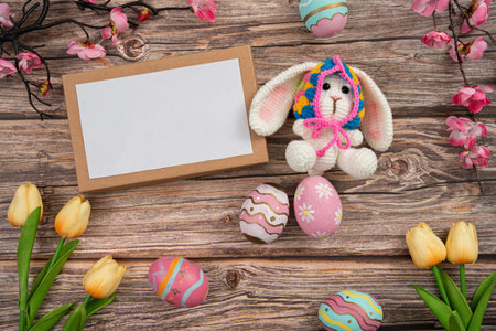 Cute Easter bunny with decorated eggs and blank card for greetings