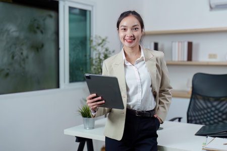 Professional woman using tablet in modern office environment
