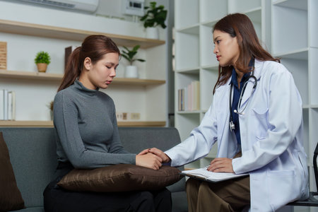 Mental Health Support. Doctor comforting a distressed patient during a consultation.の写真素材