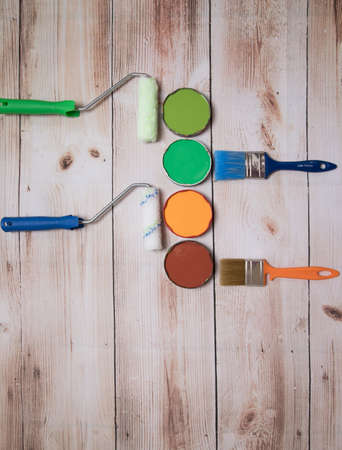 Beautifully laid out paints, brushes and rollers on a wooden surface. The concept of repairing an apartment or house with your own hands. ... Place for a copy of spaceの写真素材