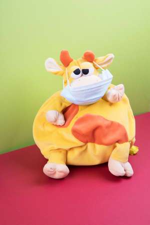The symbol of the coming year 2021 is a bull in a protective mask on a bright colored background.